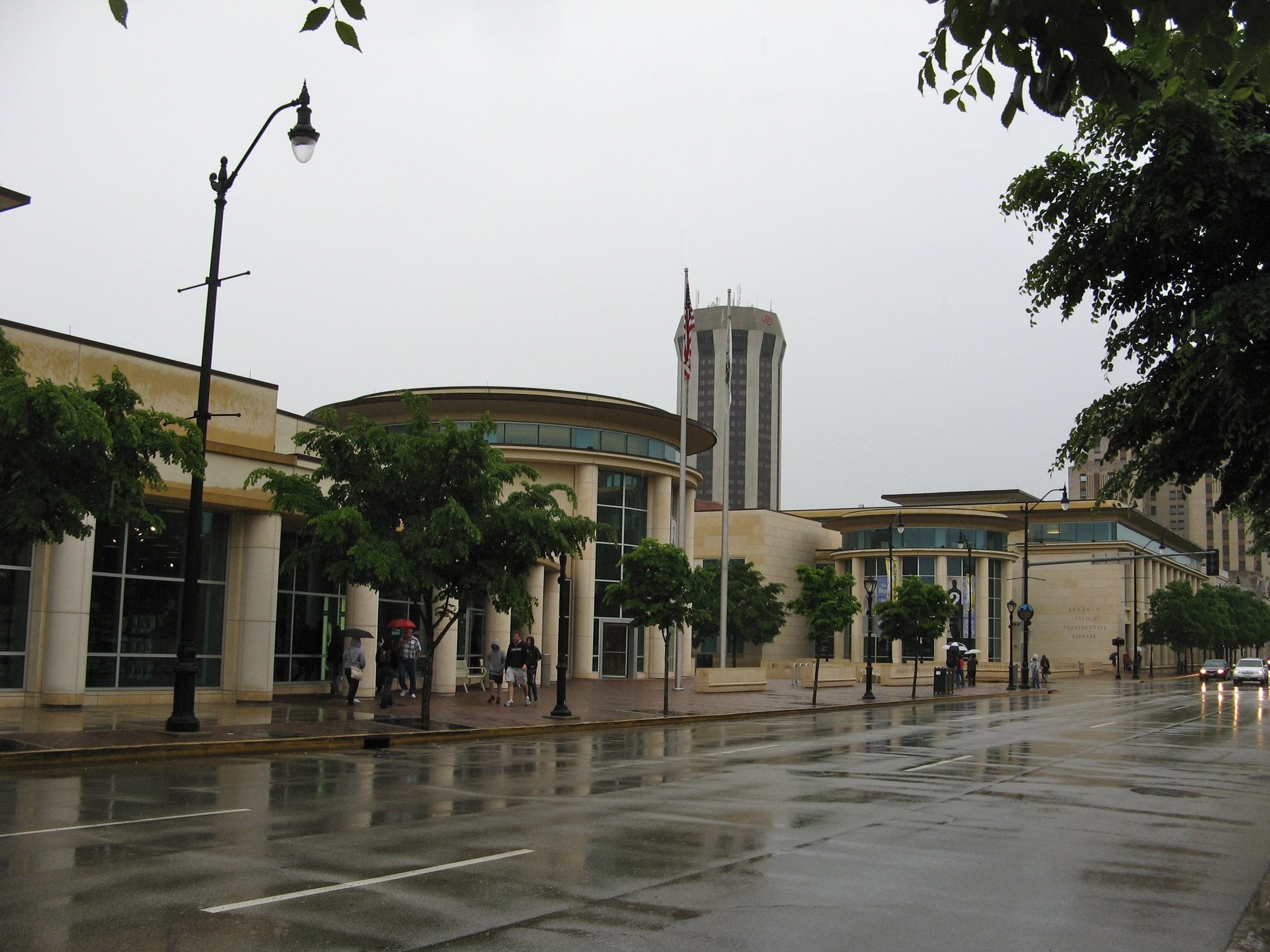 The Abraham Lincoln Presidential Library building in downtown Springfield, Illinois, seen from a wet street.