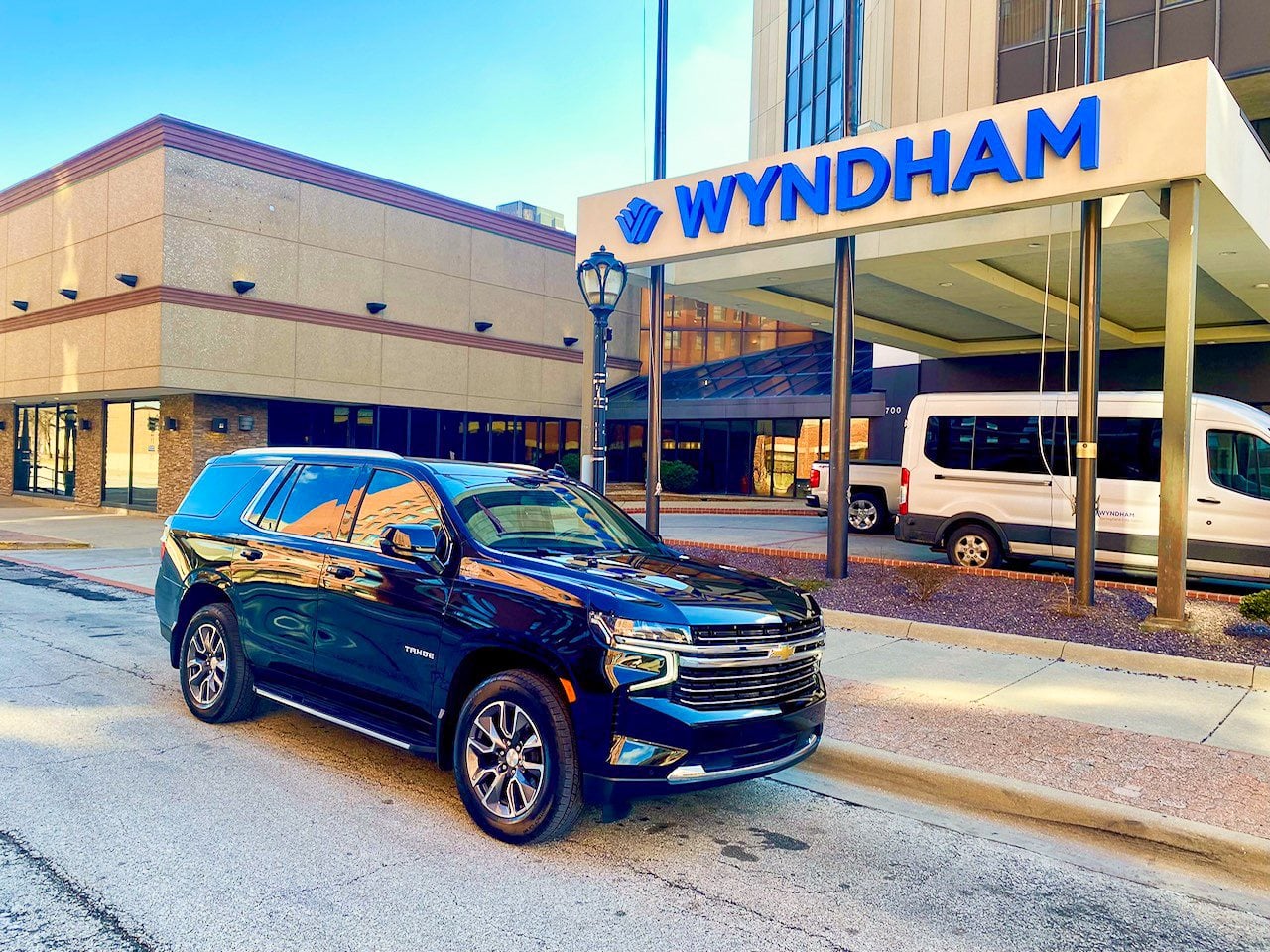 Black Chevrolet SUV parked at a hotel entrance