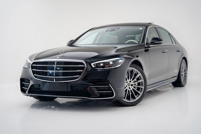 A black Mercedes-Benz S-Class sedan photographed against a clean white studio background.