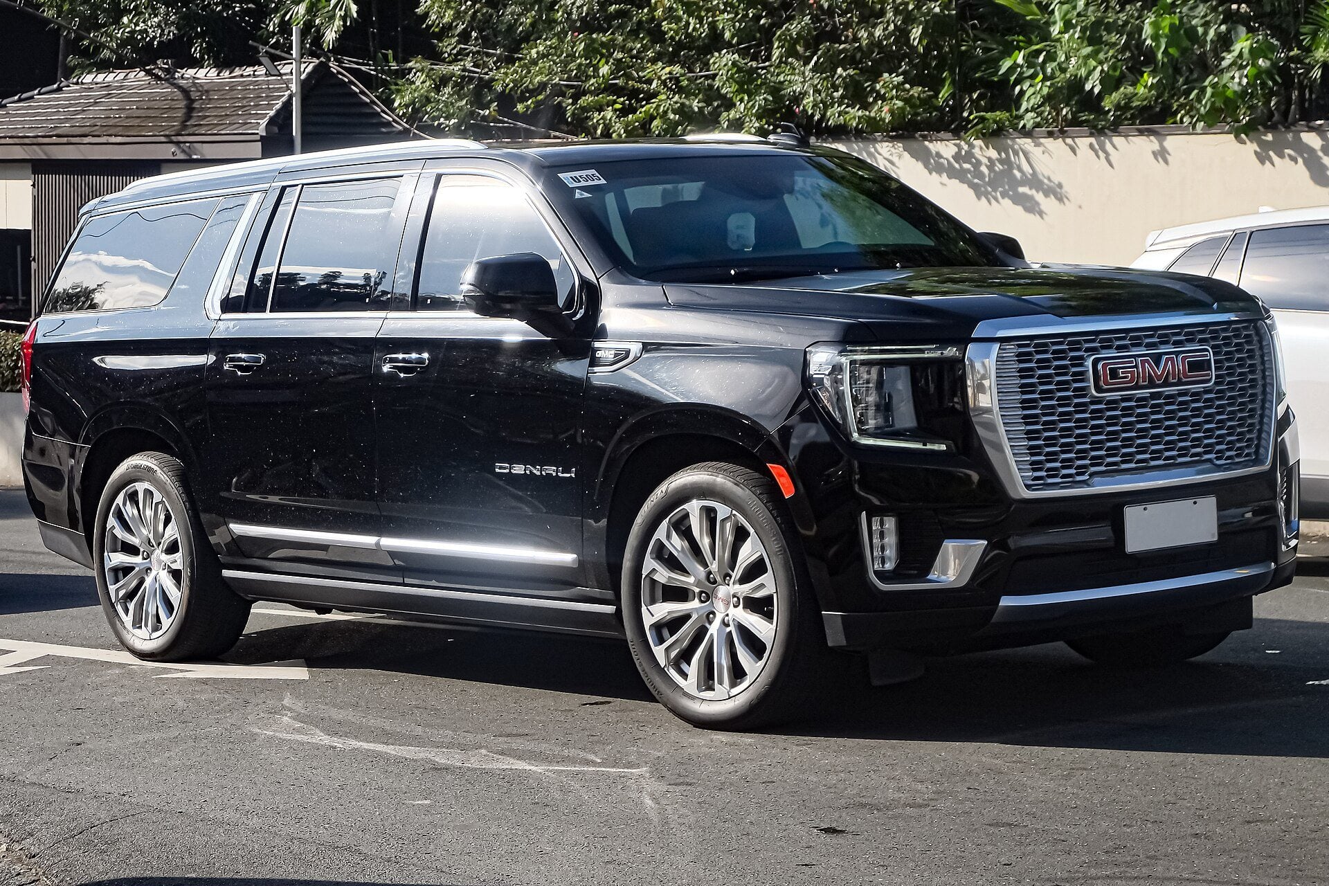 A black GMC Yukon XL Denali full-size SUV photographed from the front three-quarter angle.