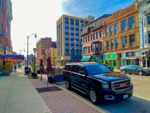 Black GMC Yukon XL parked on a downtown street