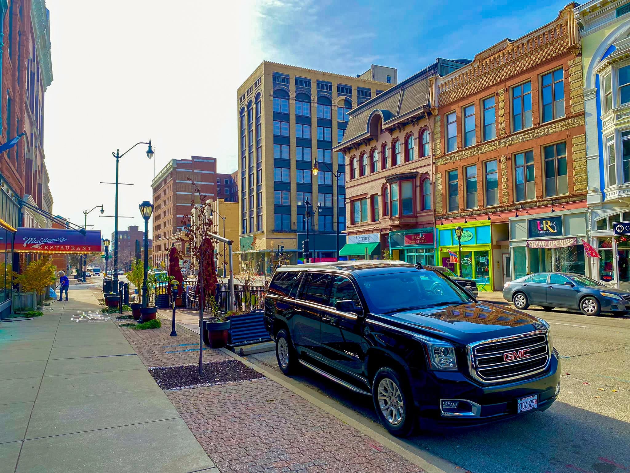 Black GMC Yukon XL parked on a downtown street