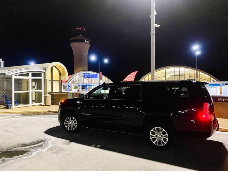 Black SUV at the St. Louis Lambert International Airport terminal at night