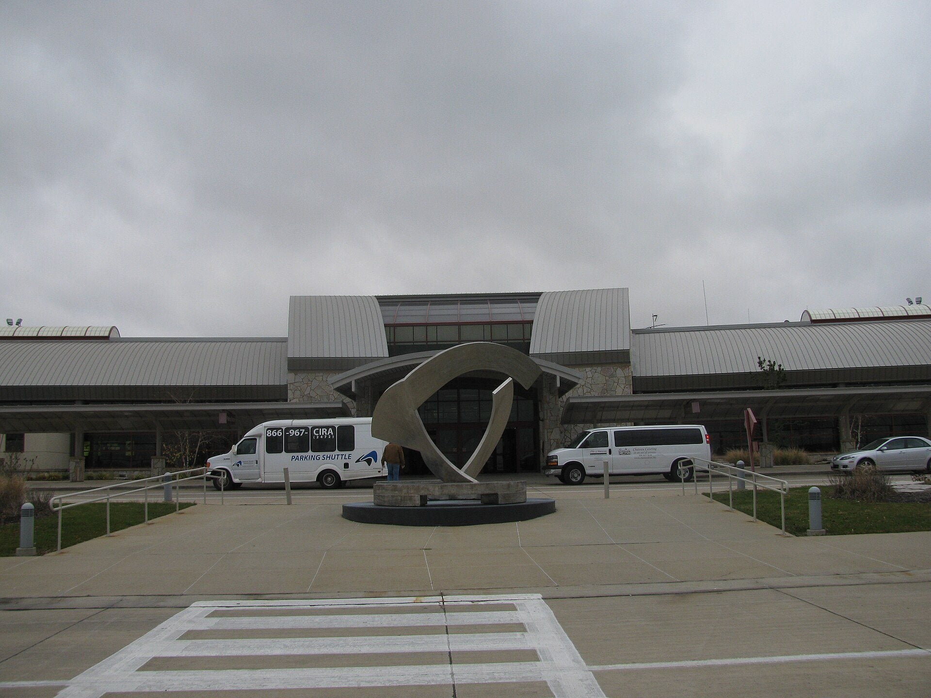 The terminal entrance at Central Illinois Regional Airport in Bloomington, Illinois, with the airport parking shuttle outside the terminal