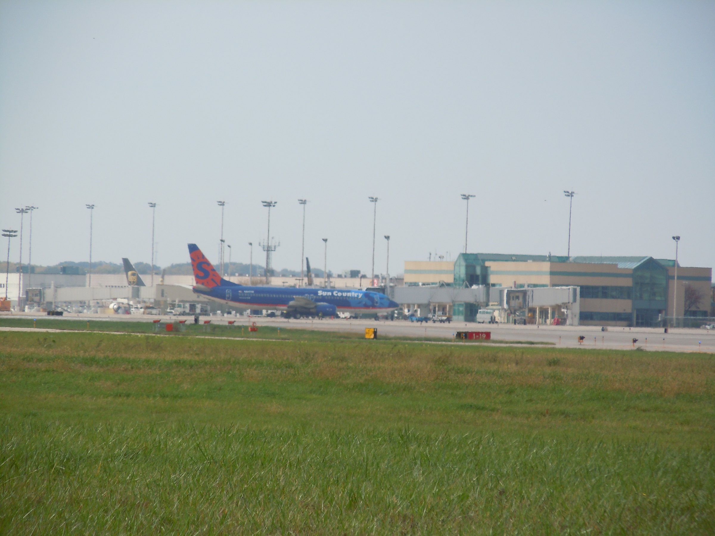 The main terminal building at Chicago Rockford International Airport seen across the airfield with an airliner parked at the gate