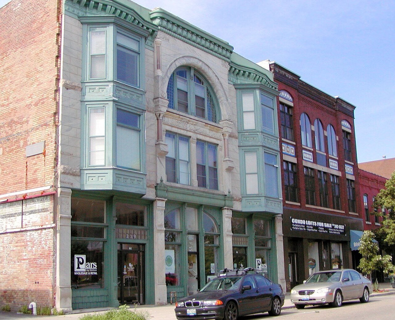 Historic brick storefronts lining a street in downtown Bloomington, Illinois.