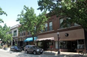 Shops and parked cars along North Neil Street in downtown Champaign, Illinois.