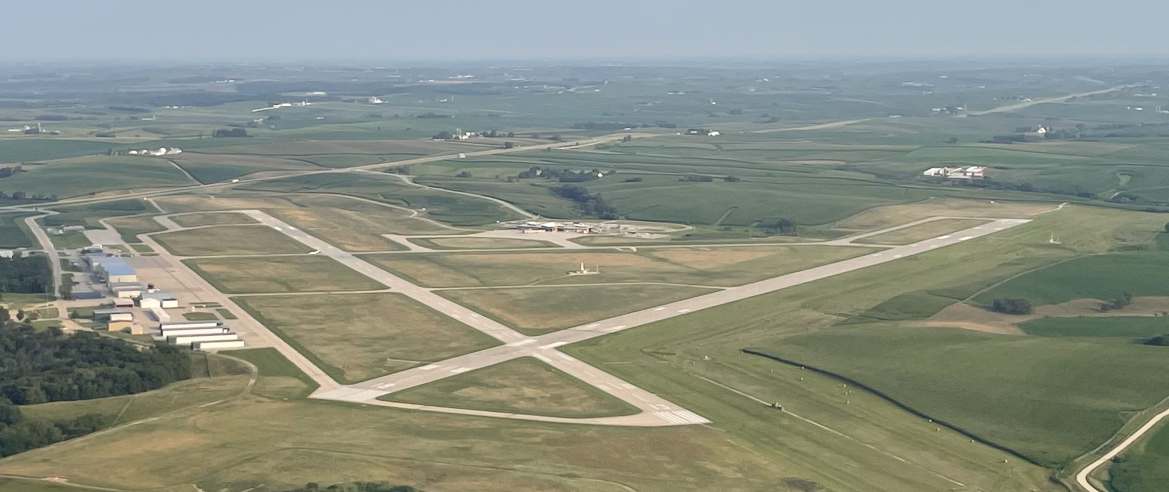 Aerial view of the runways and terminal ramp at Dubuque Regional Airport surrounded by Iowa farmland