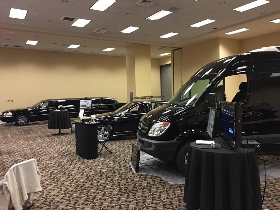 Executive Transportation vehicles lined up at an indoor event display