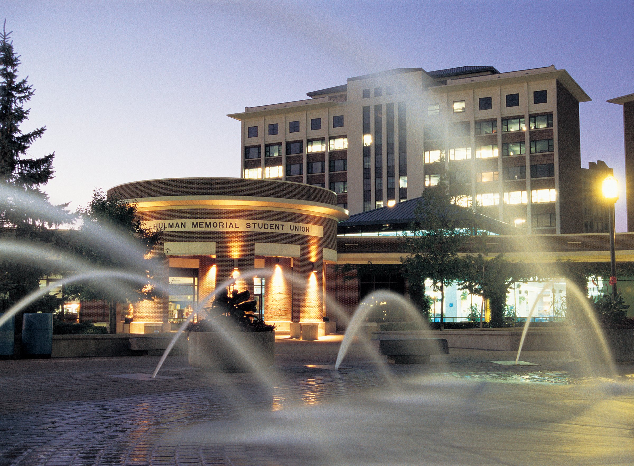 Dede Plaza and the lit Hulman Memorial Student Union on the Indiana State University campus in Terre Haute at dusk