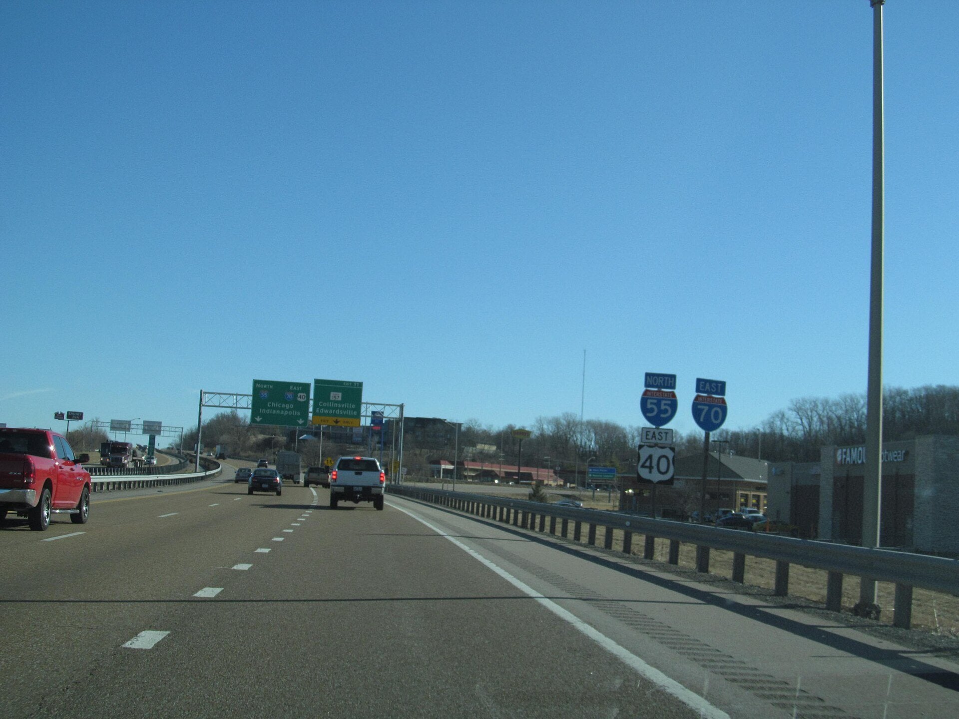 Cars and trucks traveling along Interstate 55 in Illinois beneath an overpass