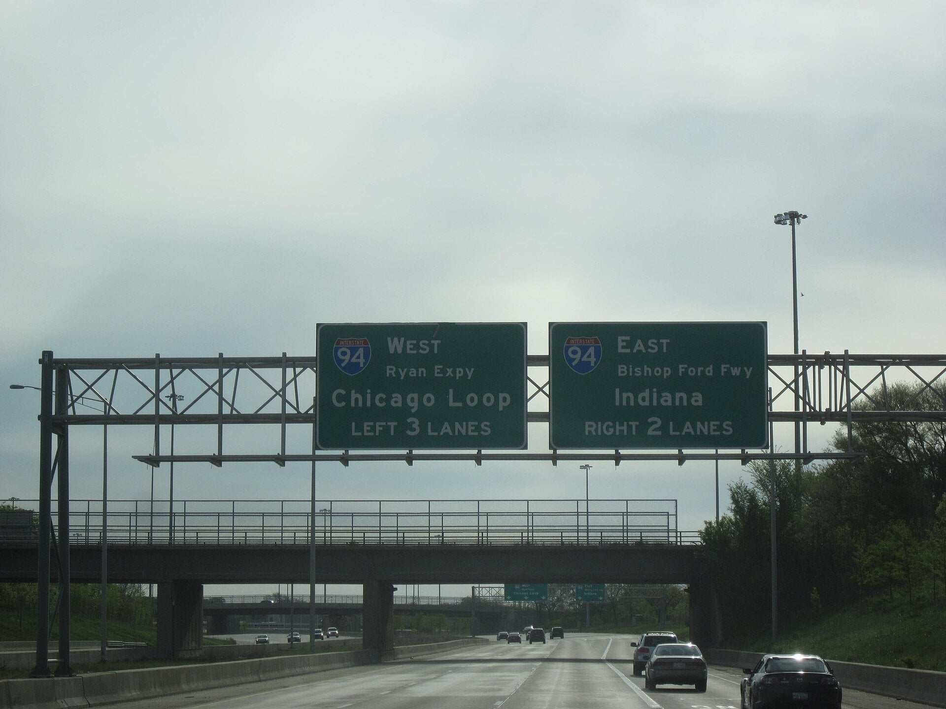 Overhead green guide signs spanning the lanes of Interstate 57 in Illinois.