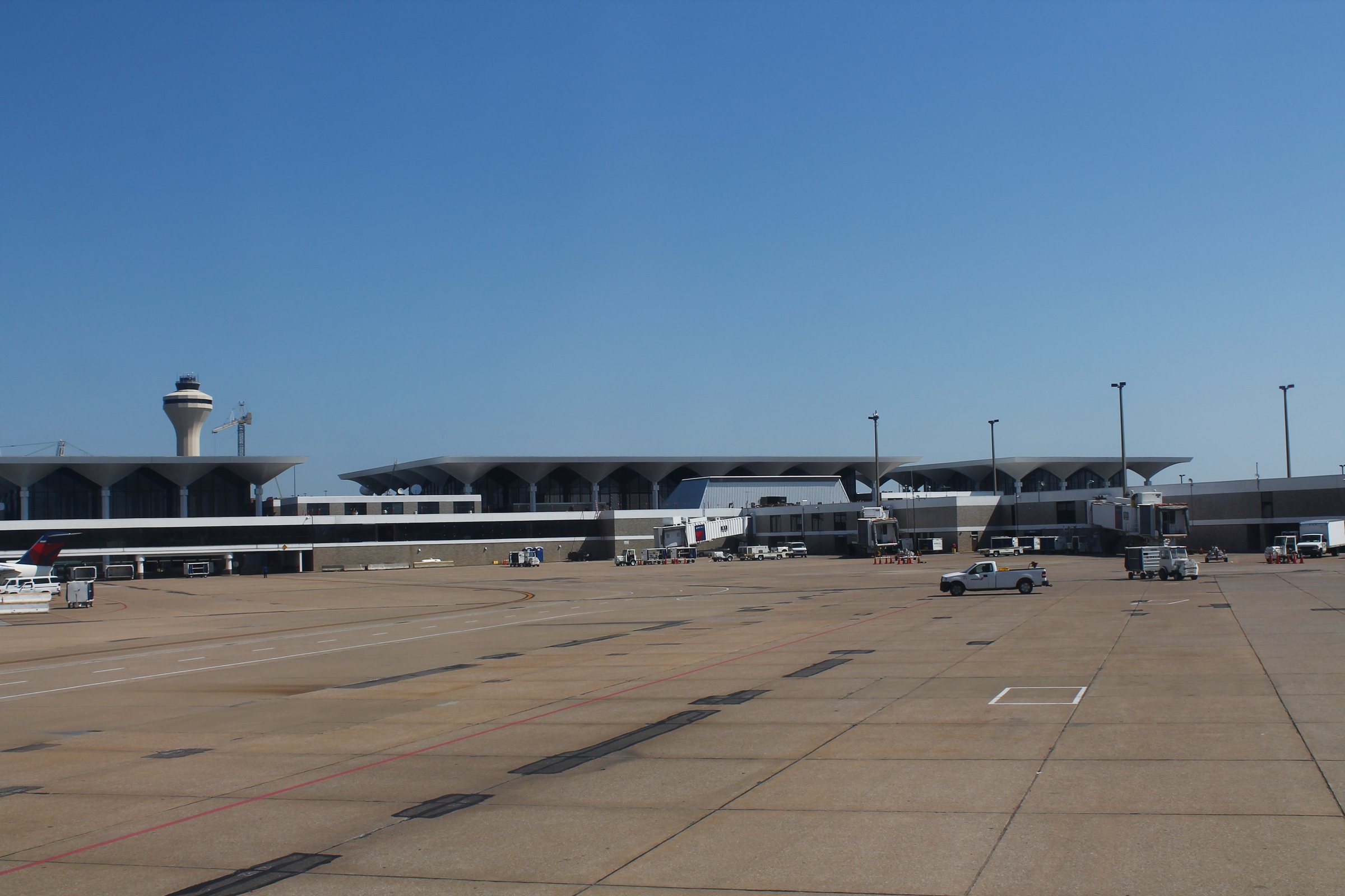 The folded concrete canopies of the main terminal at Memphis International Airport with the control tower behind them