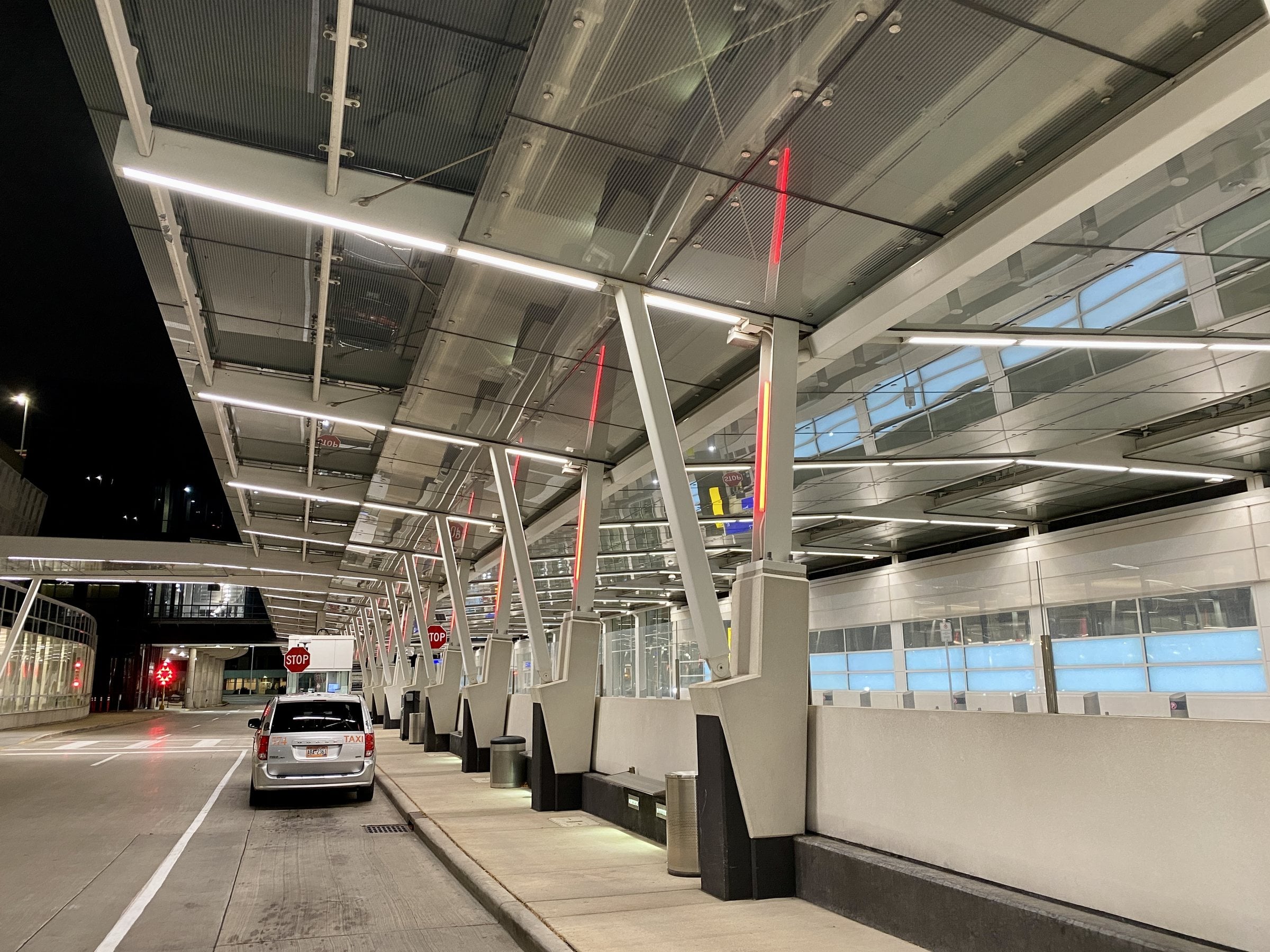 The departures roadway under the terminal canopy at Milwaukee Mitchell International Airport at night