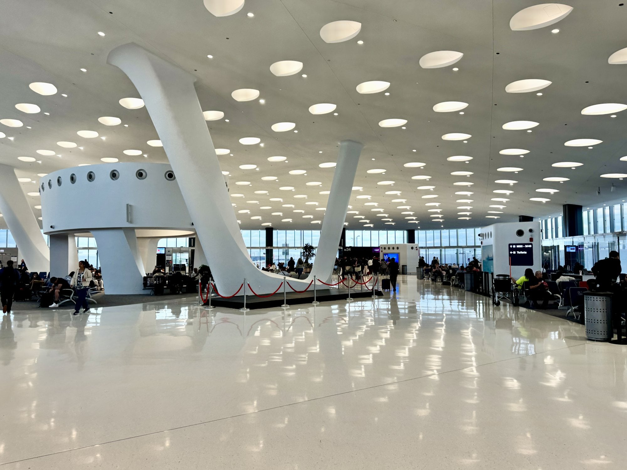 The bright concourse interior of Terminal 5 at Chicago O'Hare International Airport with sculpted white columns