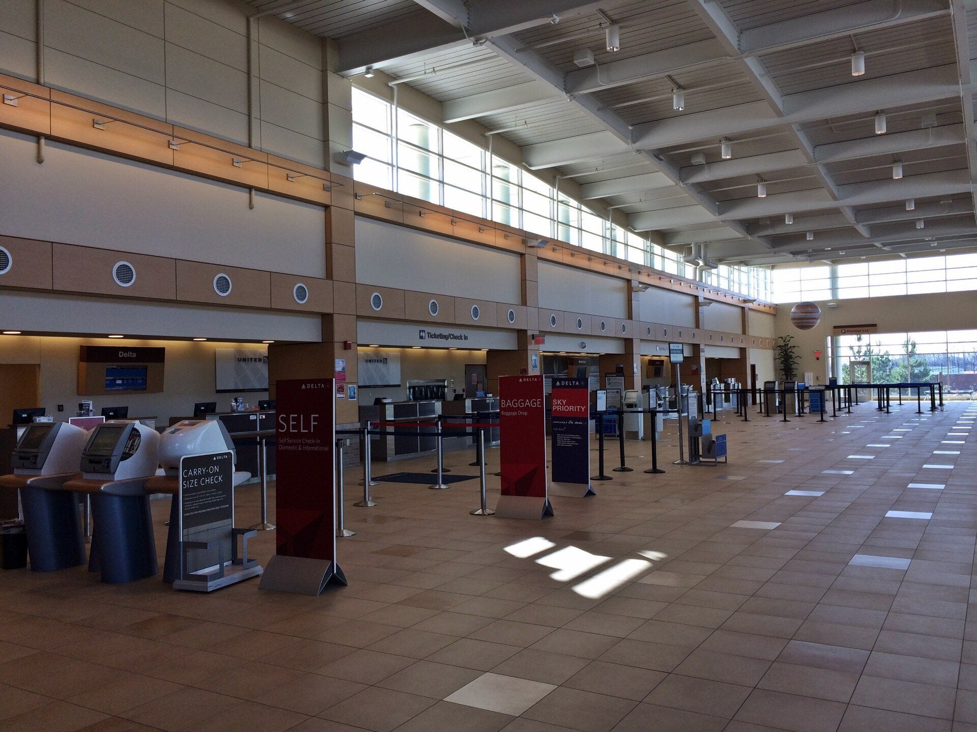 The bright ticketing and departures hall inside Peoria International Airport.