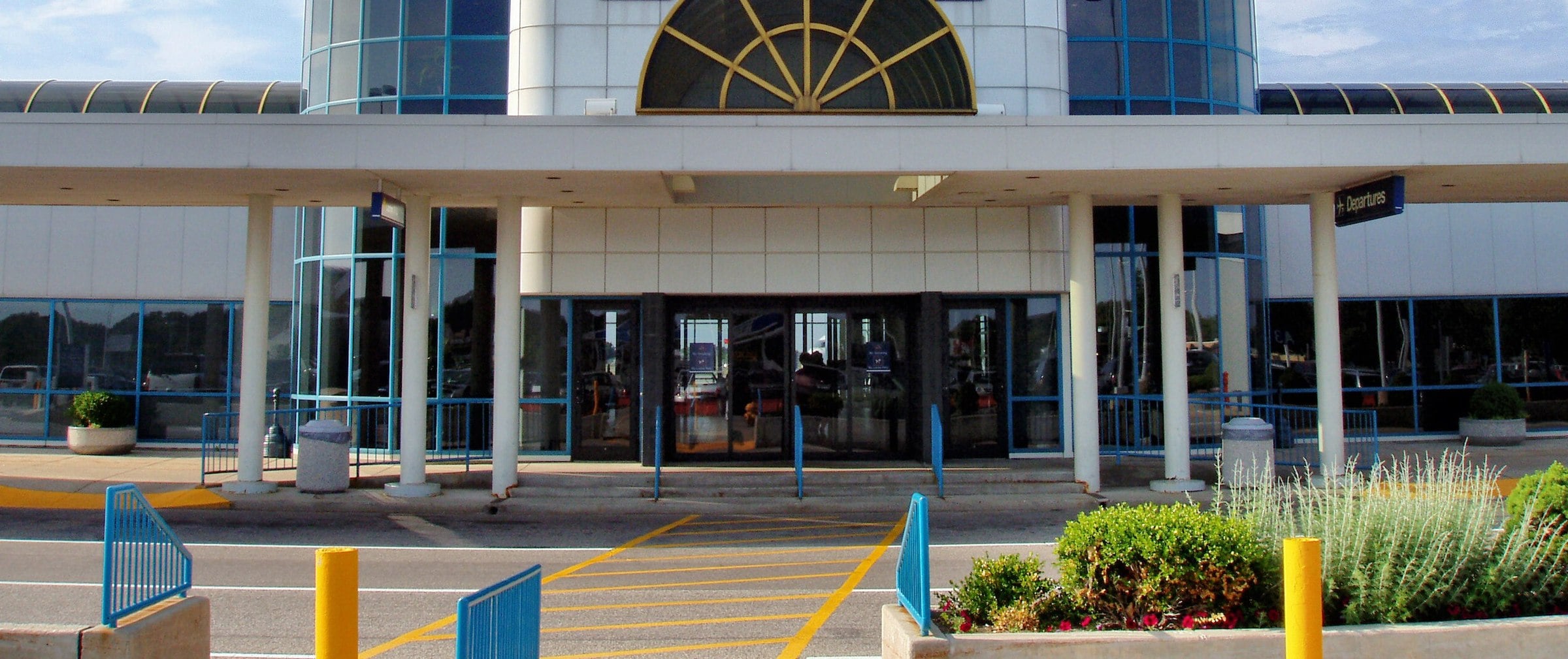 The glass terminal entrance and covered departures canopy at South Bend International Airport in Indiana