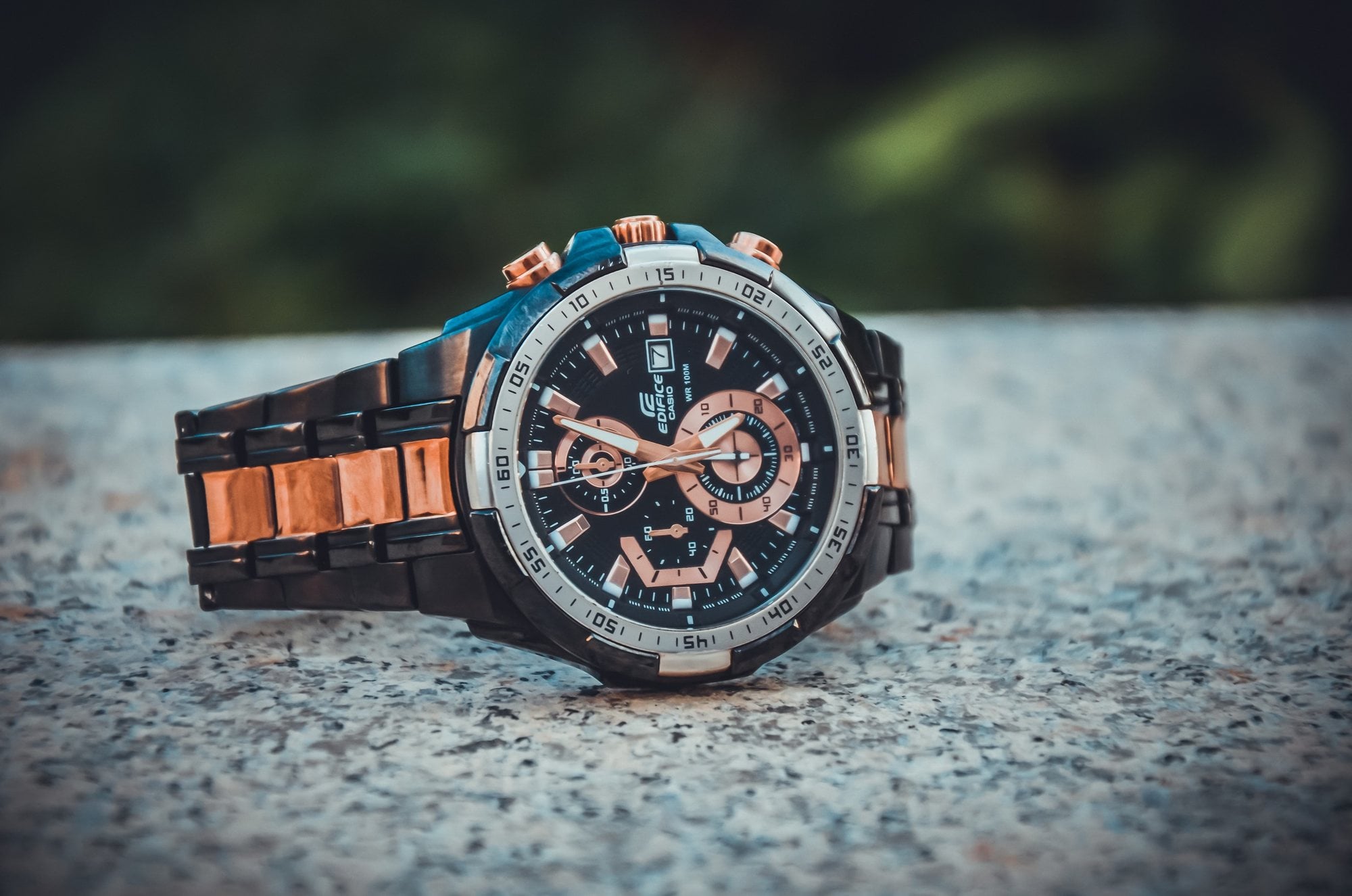 Close-up of a chronograph wristwatch with a metal band showing the time