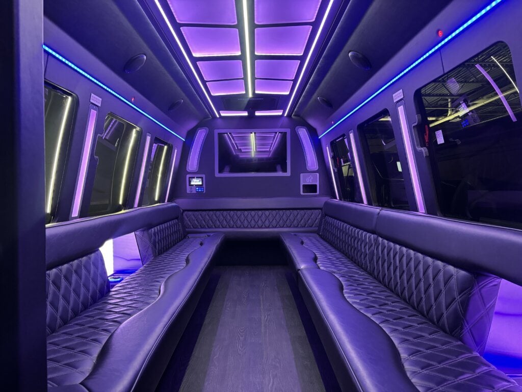 Wraparound diamond-stitched leather seating and LED lighting inside an Executive Transportation limousine coach
